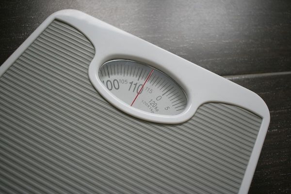 A weighing scale sitting on top of a wooden table