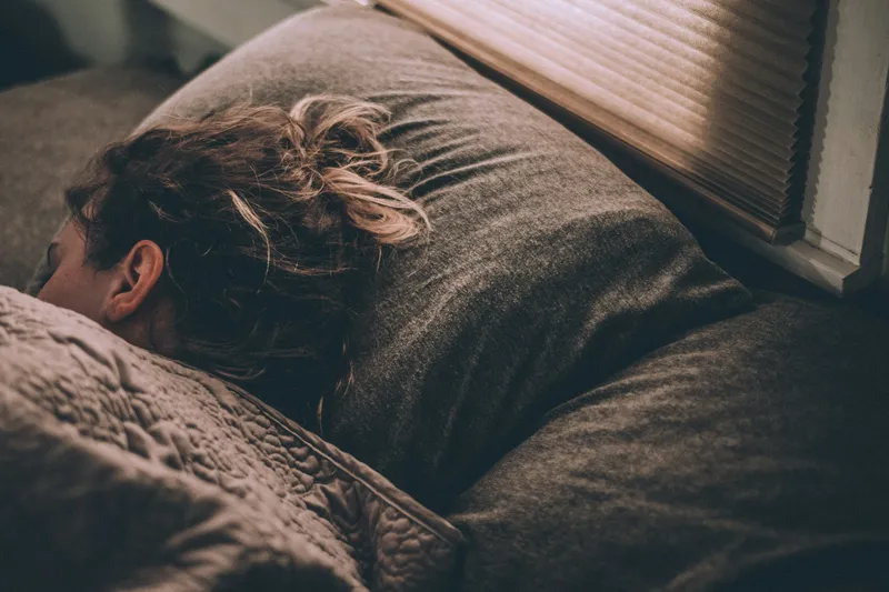 Woman sleeping on a bed