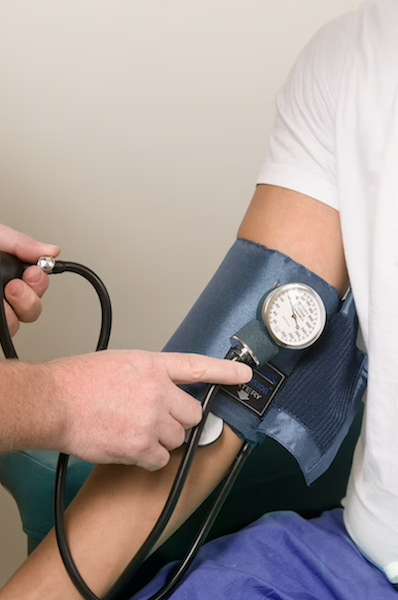 A doctor checking the blood pressure of a patient