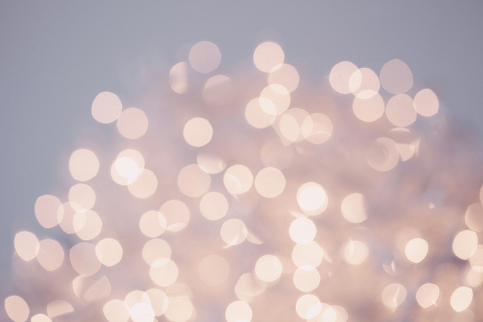  soft, out-of-focus pattern of white lights against a pale background