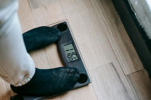 Person standing on a digital scale.